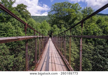 Suspension Bridge Over A Mountain River In The Carpathians
