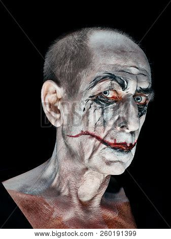 Bloody Halloween Theme: The Crazy Maniak Face On Dark Studio Background