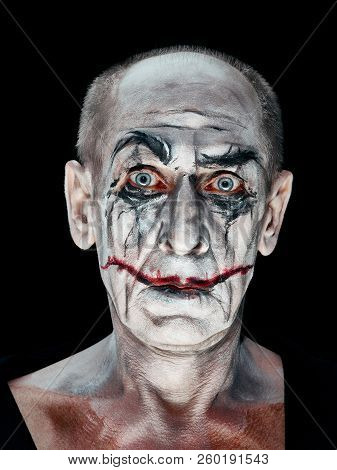 Bloody Halloween Theme: The Crazy Maniak Face On Dark Studio Background