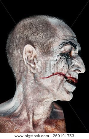 Bloody Halloween Theme: The Crazy Maniak Face On Dark Studio Background