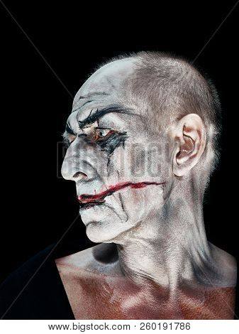 Bloody Halloween Theme: The Crazy Maniak Face On Dark Studio Background