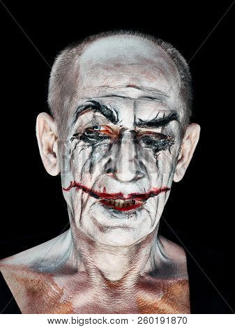 Bloody Halloween Theme: The Crazy Maniak Face On Dark Studio Background
