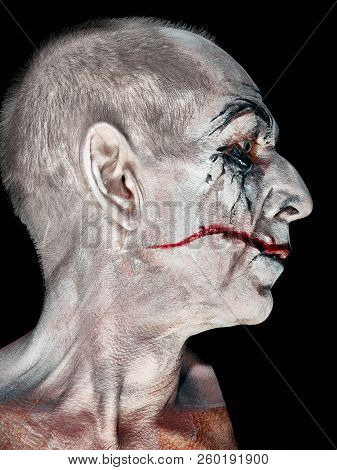 Bloody Halloween Theme: The Crazy Maniak Face On Dark Studio Background