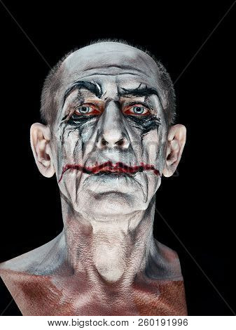 Bloody Halloween Theme: The Crazy Maniak Face On Dark Studio Background
