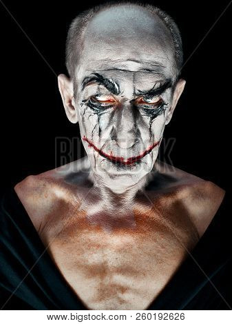Bloody Halloween Theme: The Crazy Maniak Face On Dark Studio Background
