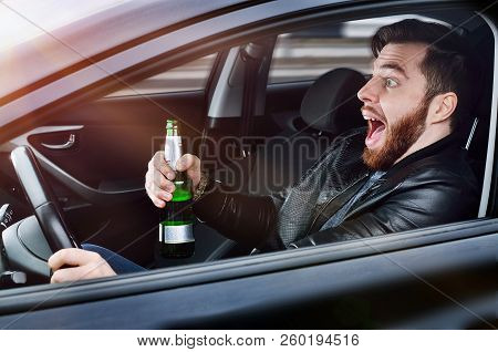 Drinks alcohol in the car. The guy with beer at the wheel. Man with beer. emergency situation. Socia