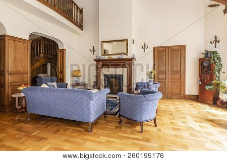 Real Photo Of A Blue Set Of Sofa And Chairs In An Elegant Living Room Interior With Wooden Furniture