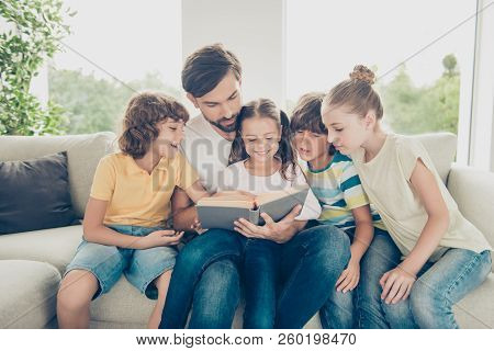 Portrait Of Family With One Parent Pre-teen Many Children Spend Free Time On Comfort, Cozy Sofa Read