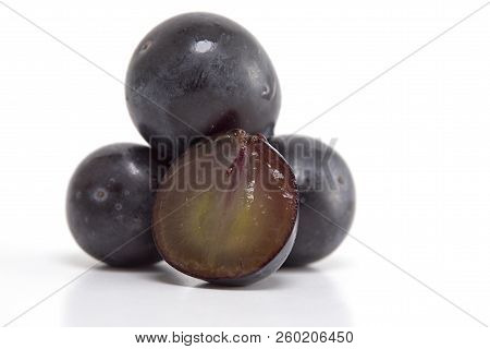 Fresh Black Grapes On White