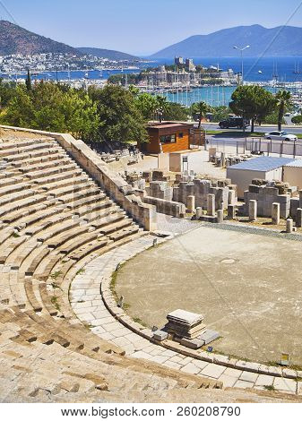 Remains Of The Amphitheatre Of Halicarnassus With Kumbahce Bay And The Castle Of Saint Peter In The 