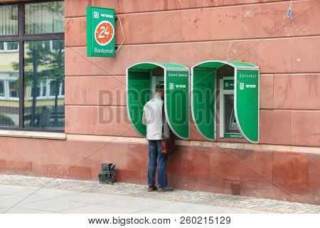 Wroclaw, Poland - May 11, 2018: Person Uses Atm Of Bank Zachodni Wbk Branch In Wroclaw, Poland. Ther