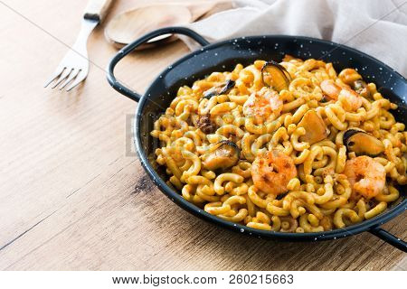 Traditional Spanish Fideua. Noodle Paella On Wooden Table. Copyspace