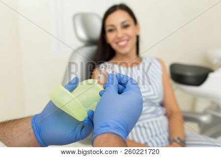 Doctor Dentist Shows Patient Tooth Whitening Tray