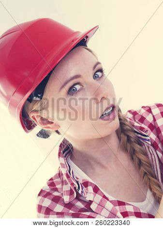 Seriously Scared Woman Wearing Red Protective Helmet. Female Construction Site Worker Looking With D