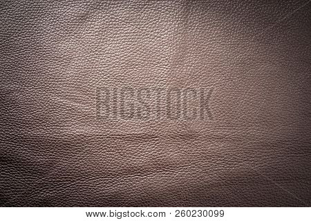 Brown genuine leather as background wallpaper with copy space 