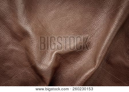 Brown genuine leather as background wallpaper with copy space 
