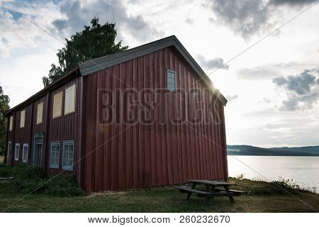 Scenic View Of Red Building Near Lake, Hamar, Hedmark, Norway