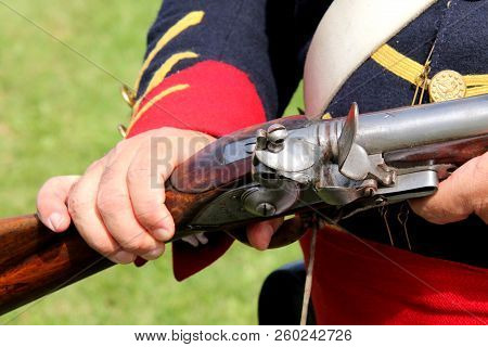 Flintlock Musket Held By A Soldier At A War Of 1812 Reenactment.