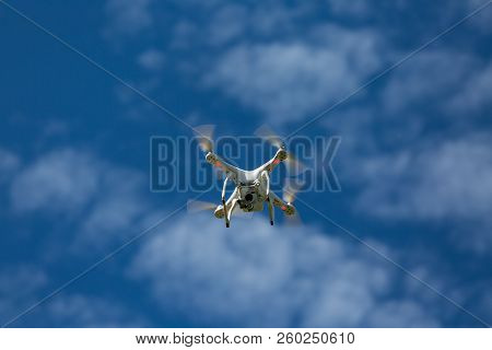 Niedernhausen, Germany, Juner 06th, 2017, Quadcopter Drone Dji Phantom Flying Into Blue Cloudy Sky