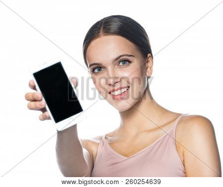 portrait of attractive young caucasian smiling woman  isolated on white studio shot  face  head and shoulders looking at smartphone telephone online happy smiling cheelful