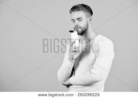 My Favorite Aroma. Man Stylish Hairstyle Holds Bottle Conditioner Grey Background. Limit Washing And