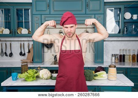 Sexy Muscular Chef In Front Of Kitchen. Attractive Chef Ready To Cook. Muscular Chef Posing In Kitch