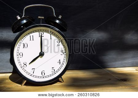 8 Am/pm Back To School Concept. Alarm Clock On Wooden With Blackboard On Background