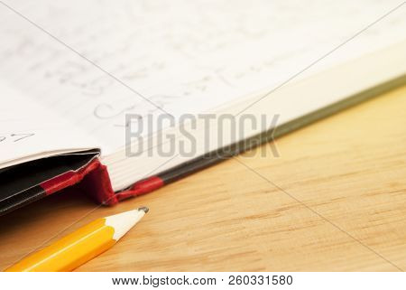 Pencil Oand Opened Notebok White Paper Sheet Over Wooden Table. Copy Space.