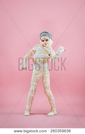 Studio Image Of A Young Teen Girl Bandaged, On Pink Background. Bloody Halloween Theme: The Crazy Ma