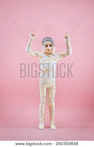 Studio Image Of A Young Teen Girl Bandaged, On Pink Background. Bloody Halloween Theme: The Crazy Ma
