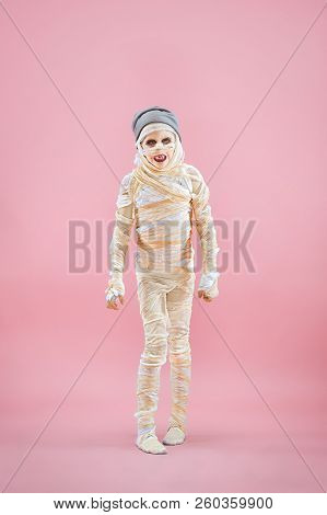 Studio Image Of A Young Teen Girl Bandaged, On Pink Background. Bloody Halloween Theme: The Crazy Ma