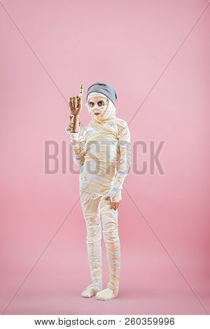 Studio Image Of A Young Teen Girl Bandaged, On Pink Background. Bloody Halloween Theme: The Crazy Ma