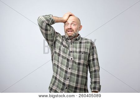 Nervous Scared European Guy Has Sorrorful Expression, Holding Hands On Head Finds Out About Tragic E