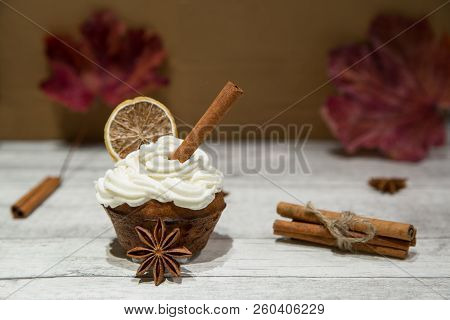 Pumpkin Spice Muffin Frosted With Mascarpone Chesee And Cream, Whipped 
Icing, Decorated With Cinnam