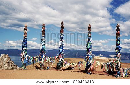 Vivid Colored Ribbons Hadak Tied On Posts Of Wish. Wooden Ritual Pillars. Sacred Place Of Buddhist S