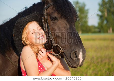 Young blond woman in red dress  with horse