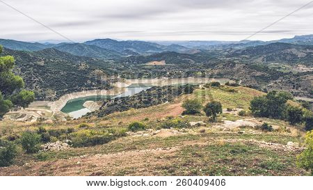 Mountain Landscape With Mountains In The Background And A River Located In The Interior Of Valley.
