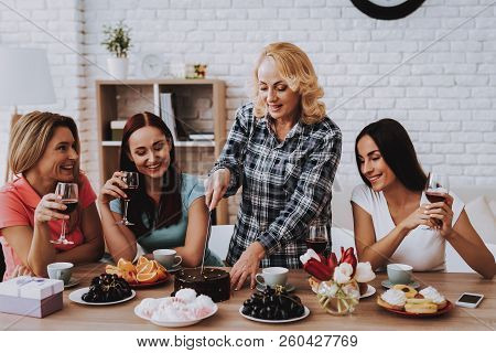 Lady Cut Cake For Friends. Happiness Time For All Family. Smile And Young Girl Celebrate Together. C