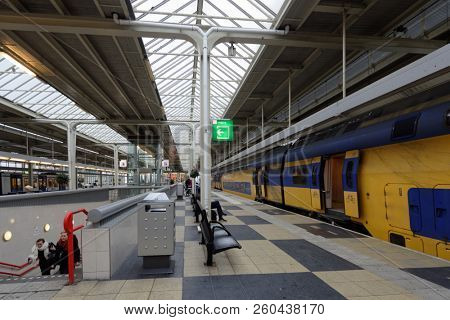 AMSTERDAM, NETHERLANDS - JANUARY 1, 2017: People on the platform of metro and train station. The metro system consists of five routes and serves 58 stations, with a total length of 52.2 km