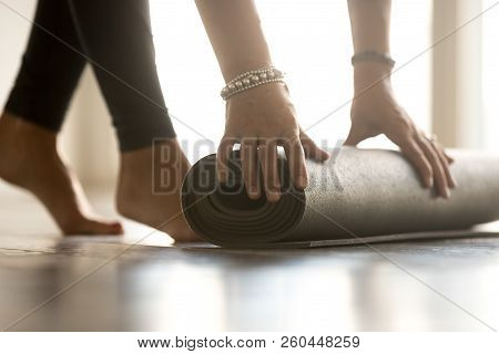 Girl Folding Fitness Yoga Mat After Gym Class, Close Up