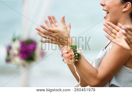 Wedding guests clapping for the bride and groom