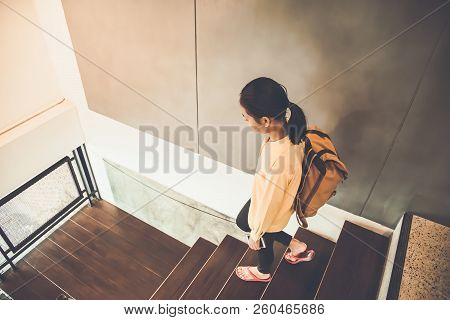 The Tourists Are Walking Down The Stairs To Leave The Hotel.