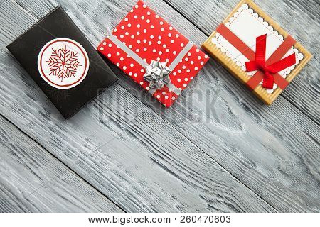 Gifts In Colorful Boxes With Bow For Holiday, In A Iwooden Background