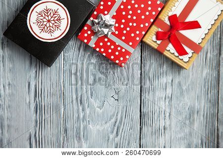 Gifts In Colorful Boxes With Bow For Holiday, In A Iwooden Background