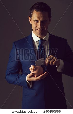 Happy Man, Successful Businessman Or Handsome Manager Putting Business Card In Piggy Bank In Blue Su