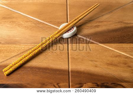 Natural Bamboo Chopsticks On Wooden Table Background.