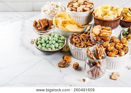 Variation Different Unhealthy Snacks Crackers, Sweet Salted Popcorn, Tortillas, Nuts, Straws, Bretse