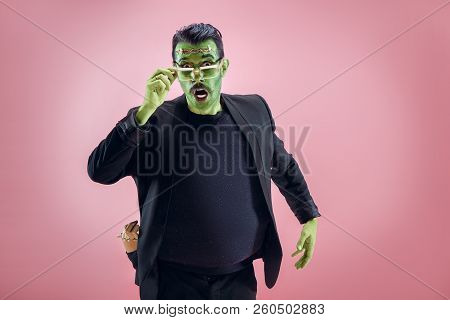 Bloody Halloween Theme: The Crazy Maniak Face On Pink Studio Background