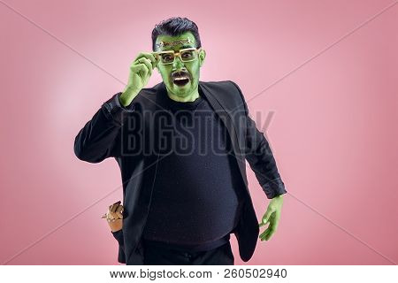 Bloody Halloween Theme: The Crazy Maniak Face On Pink Studio Background