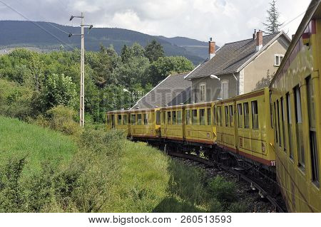 Latour De Carol - September 4, 2018: The Small Yellow Train Of The Pyrenees Crossing A Beautiful Mou